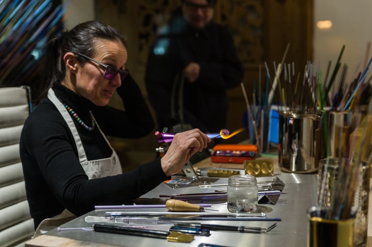 Craftswoman at work carving.