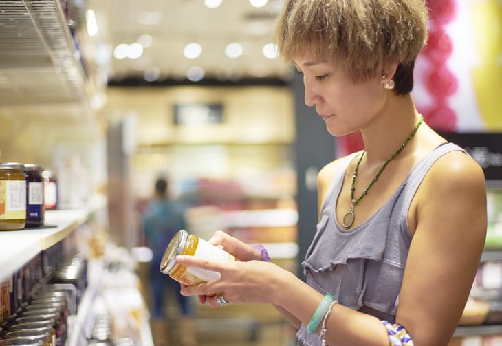 Woman checking an expiration date