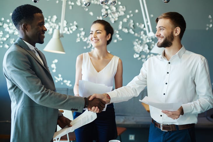People finalizing a deal, shaking hands.