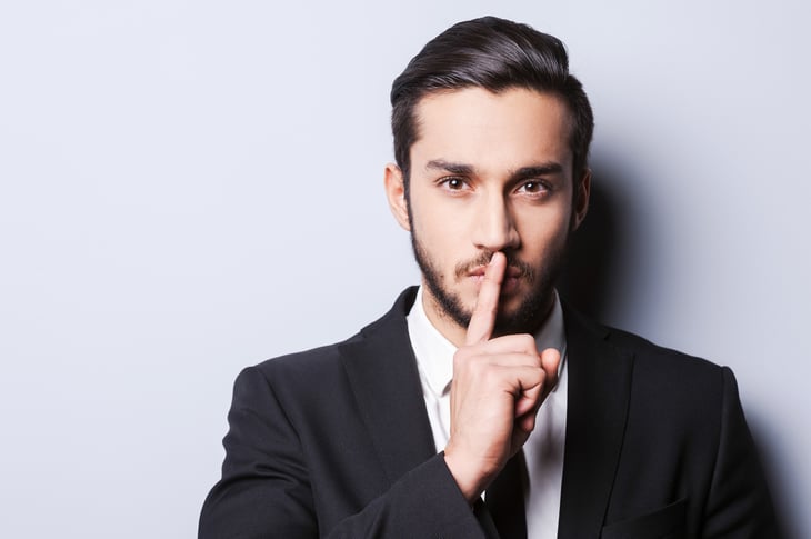 Businessman gesturing quiet
