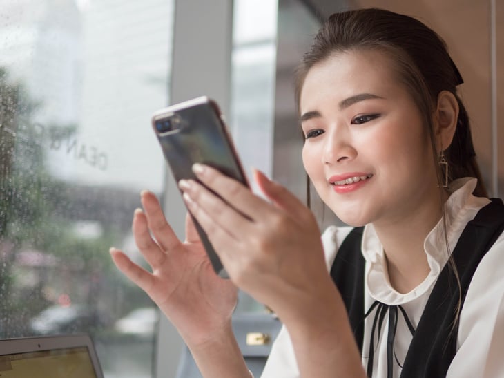 Businesswoman looking at her smartphone