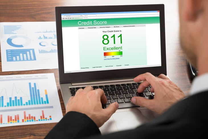 A man checking credit score on a laptop
