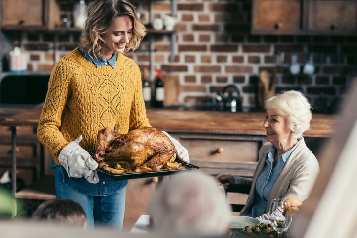 Woman carrying thanksgiving turkey