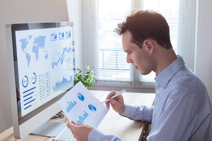 A man studies financial data at his computer