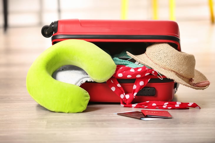 Travel pillow and suitcase.