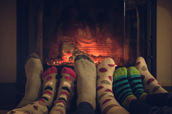 Feet with warm socks in front of the fire