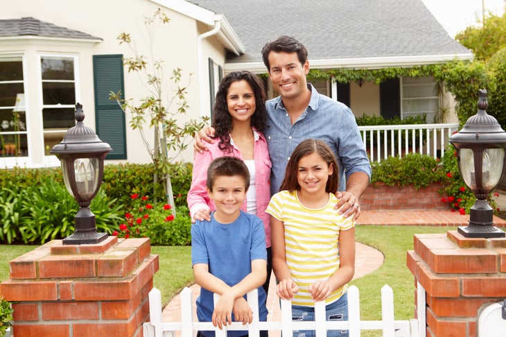Family in front of home