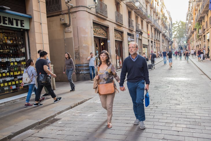 Tourist couple walking on street in Europe.