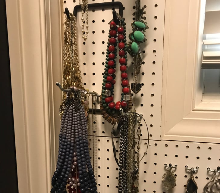 Necklaces hanging on wall.