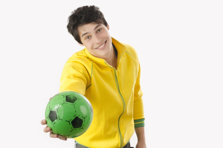 Person holding out soccer ball.