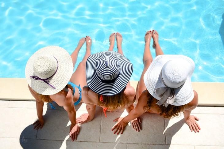 Women sitting poolside