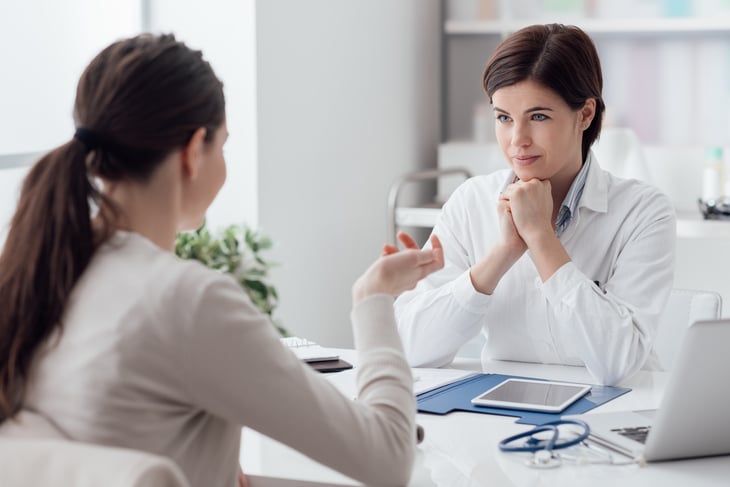 Doctor talking to a patient at her office
