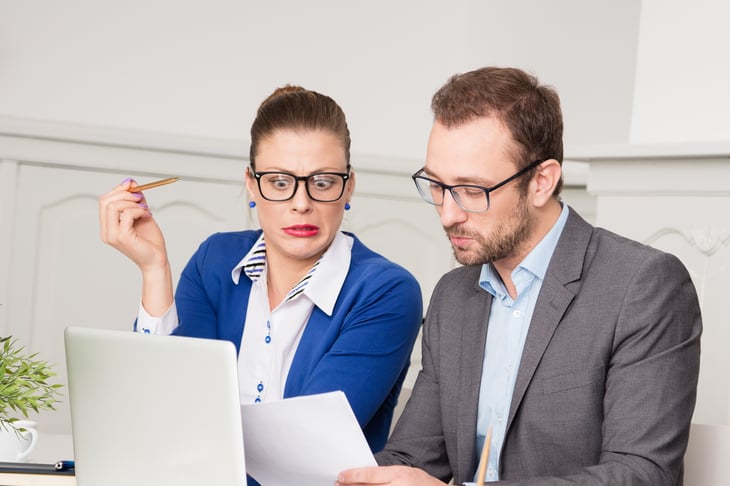 Shocked woman after looking at fees