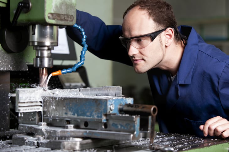 Metal worker at milling machine