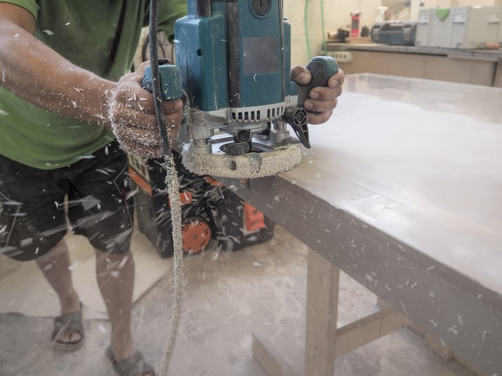 Worker sanding acrylic countertop