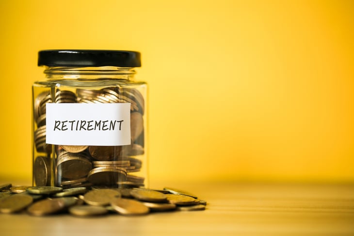 Jar labelled "retirement" with coins in and around.