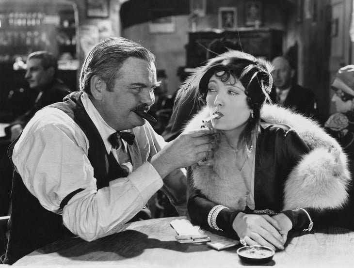 Vintage picture of man and woman smoking.