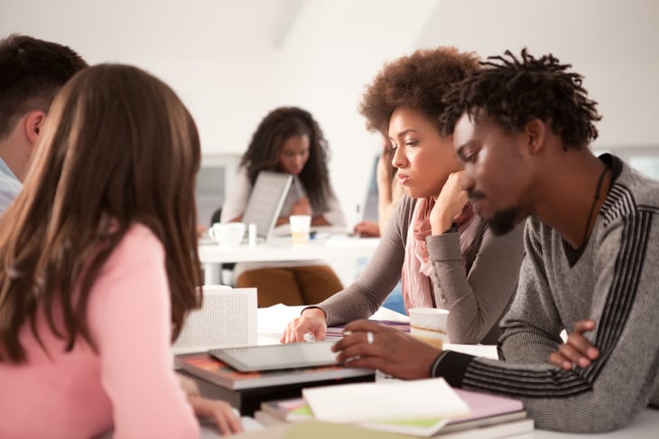 College students working together at a table.