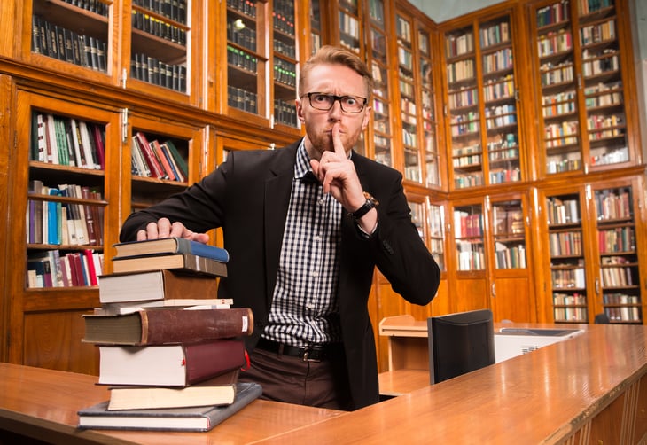 Librarian with shelves of books