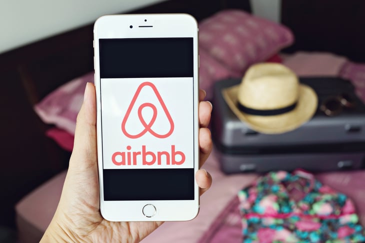 Airbnb logo on a smartphone screen
