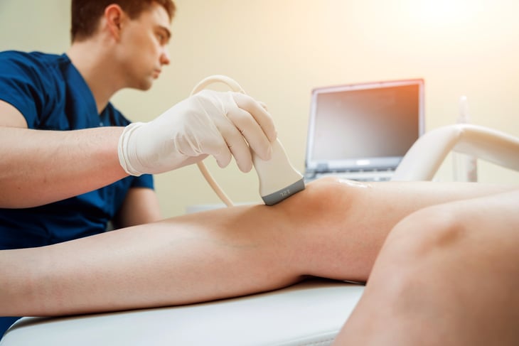 Sonographer examining patient's knee