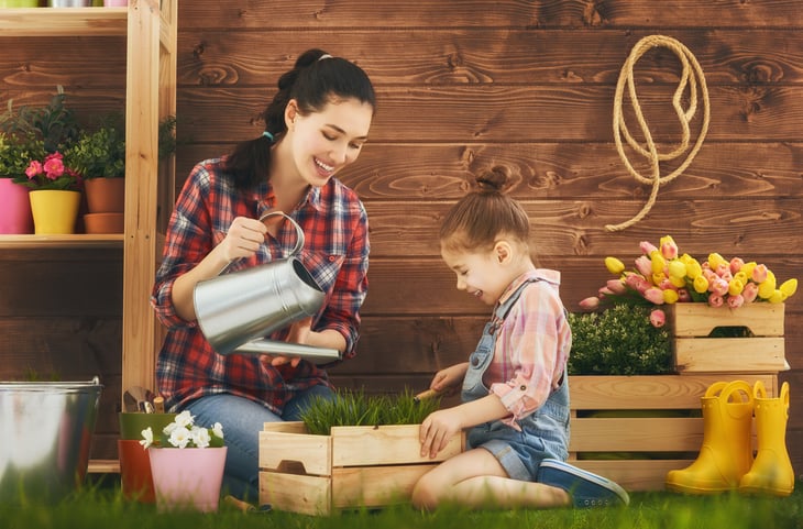 Woman and little girl gardening