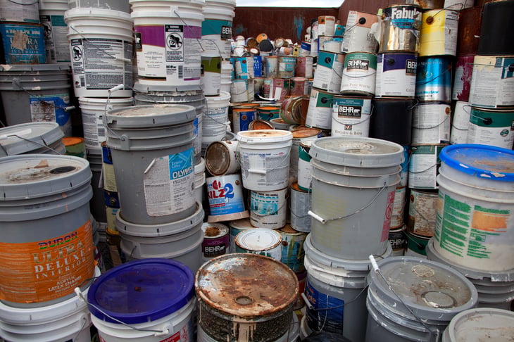 Stacks of used paint cans and other materials.