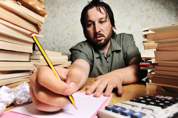Man at desk working hard, sweating