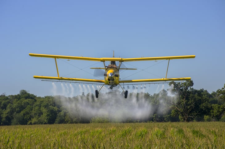 Crop duster over a farm in Iowa