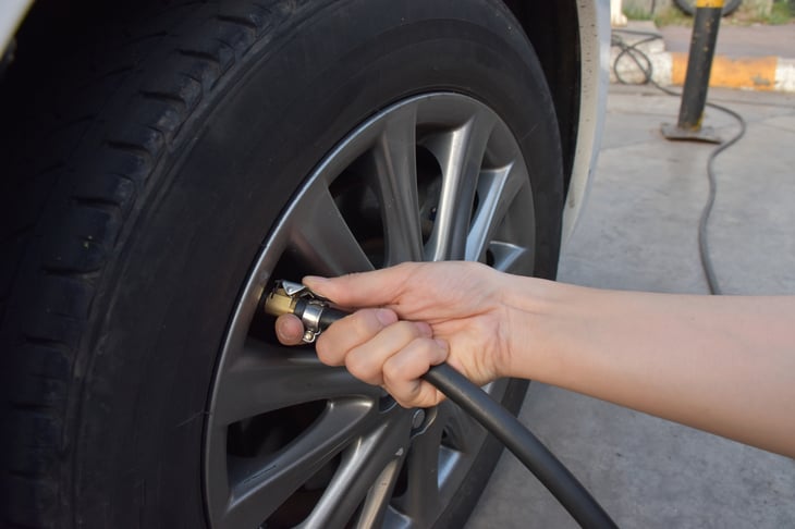 A person puts air into a tire