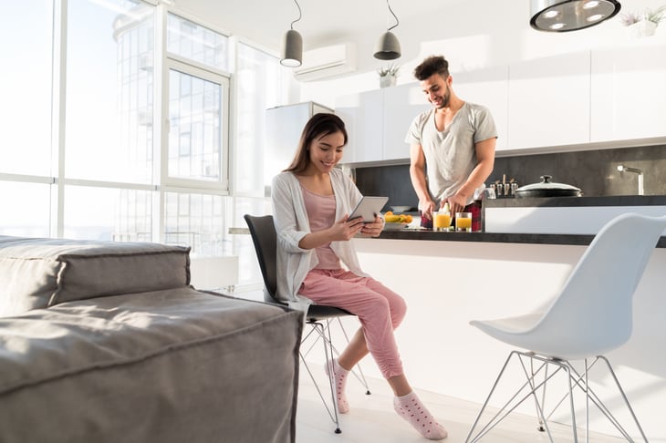 A couple in a brightly lit apartment