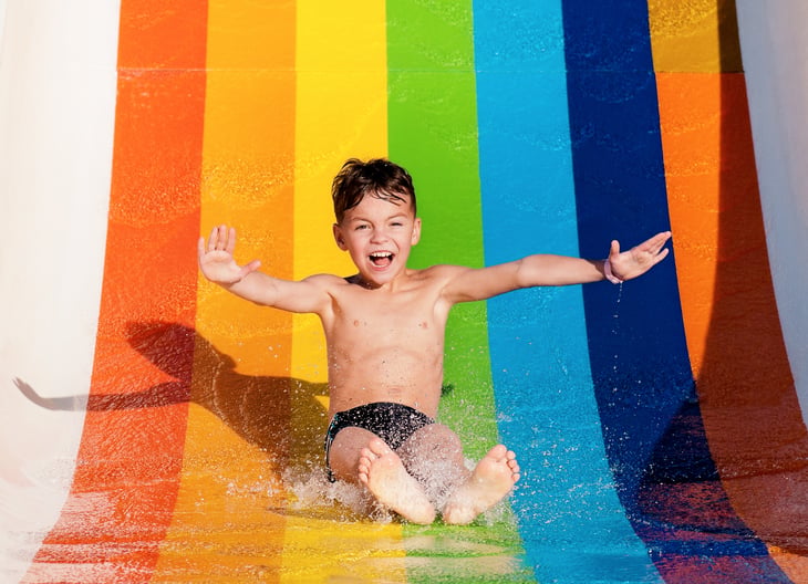 A kid on a water slide