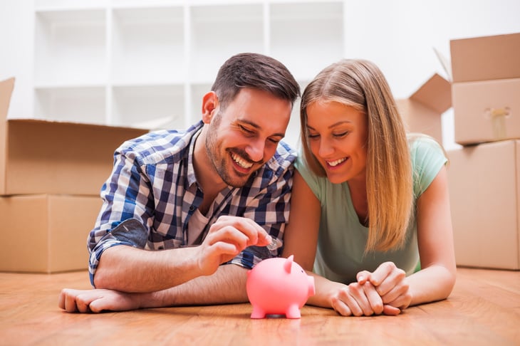 Happy couple saving money