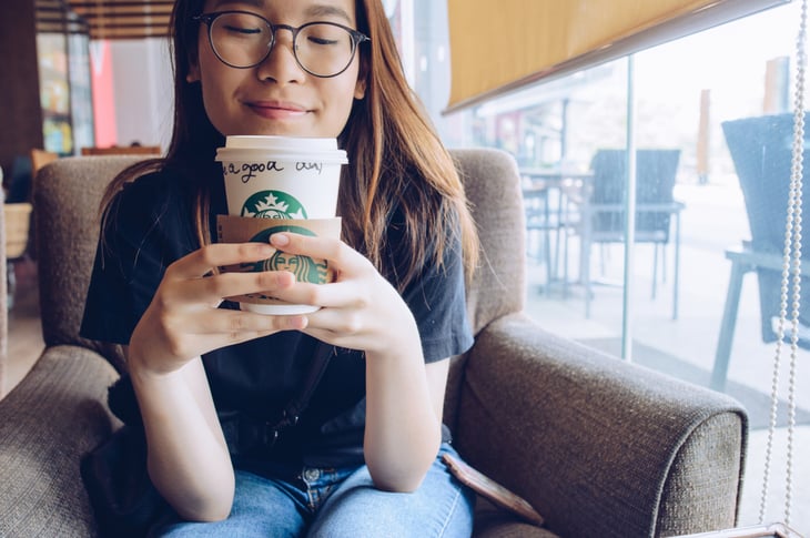 A woman drinks Starbucks coffee