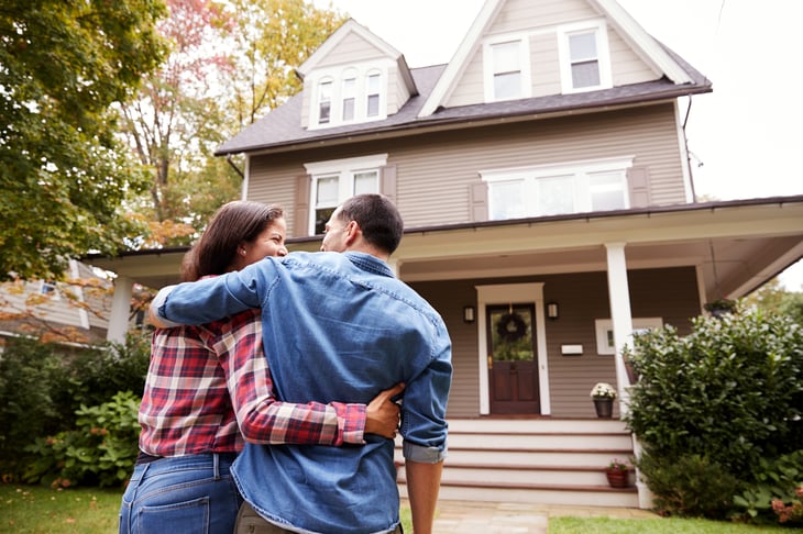 Couple outside a home