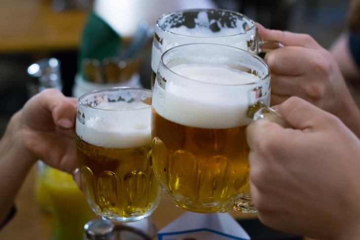 Making a toast with beer glasses