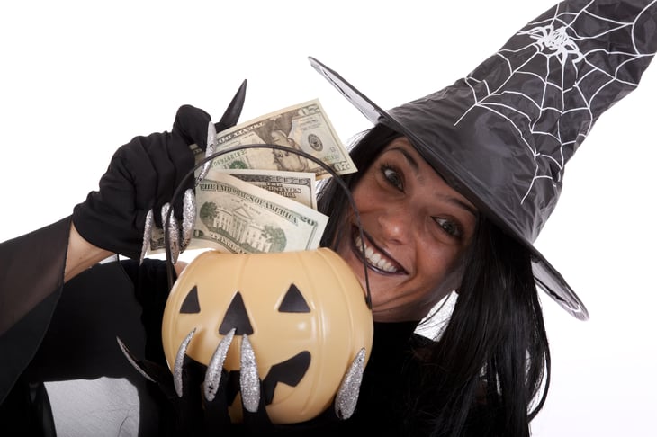 Halloween witch saving money on her pumpkin