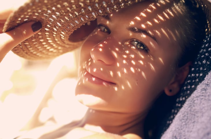 Woman in sun, with sun hat