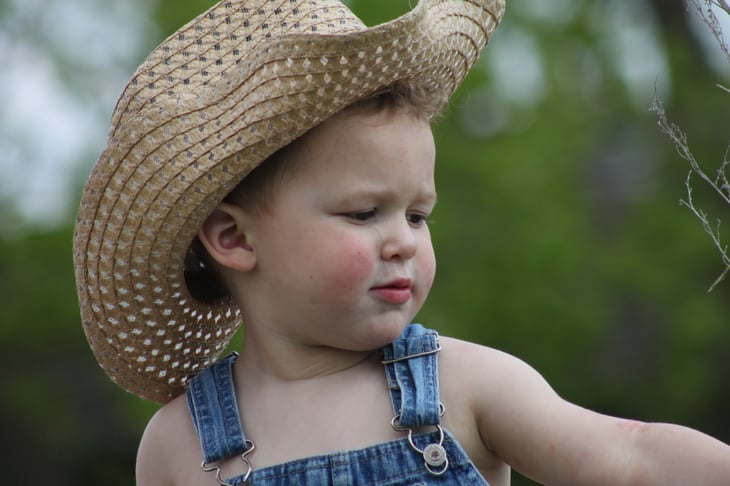 Little boy with cowboy hat on North Dakota Farm