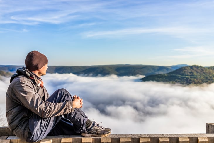Man looking at mountains
