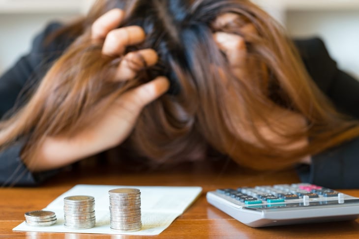 Stressed businesswoman running out of money - stock and market down