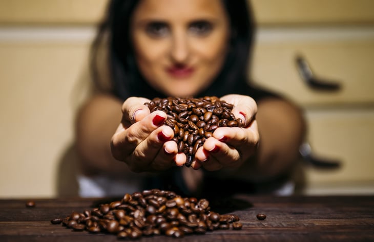 Woman holding coffee beans