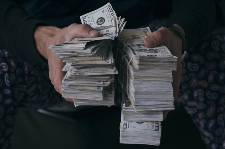 Hands holding stacks of money
