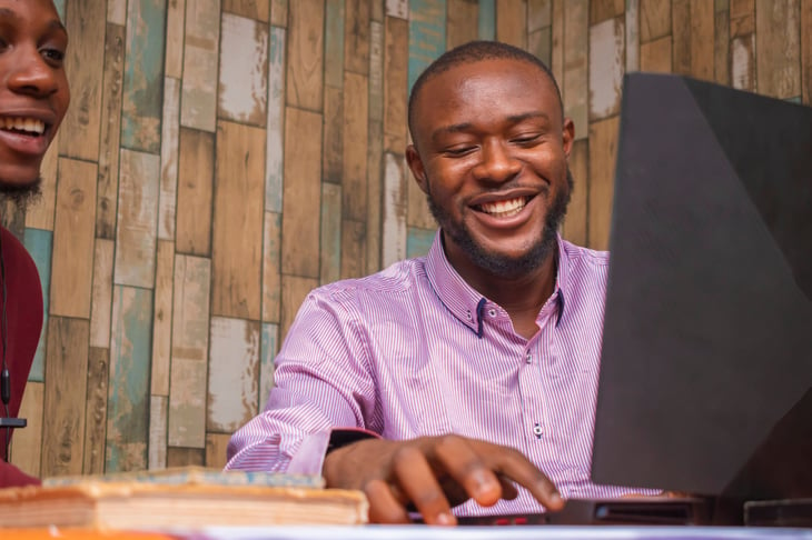 Black man young happy planning computer laptop