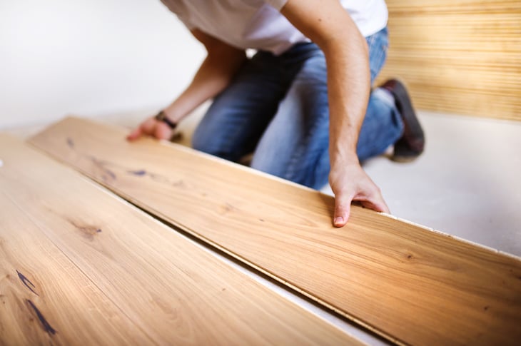 Worker installs flooring