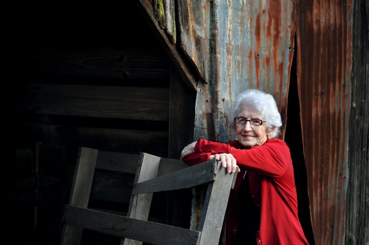 Woman by old Arkansas barn