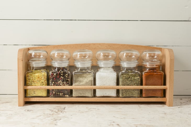 Rack of jars with dried herbs and spices