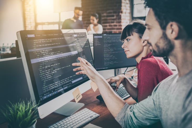 Web developers looking at screen