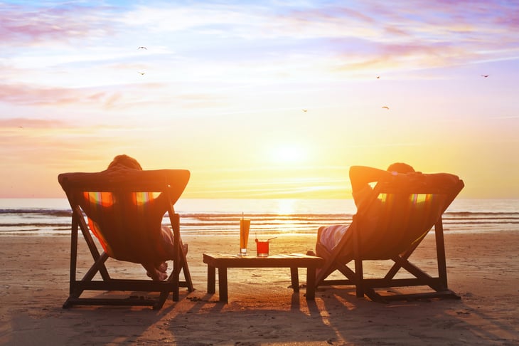 People sitting on the beach at sunset