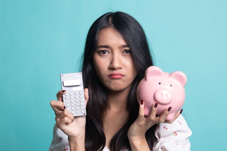 Unhappy woman with piggy bank